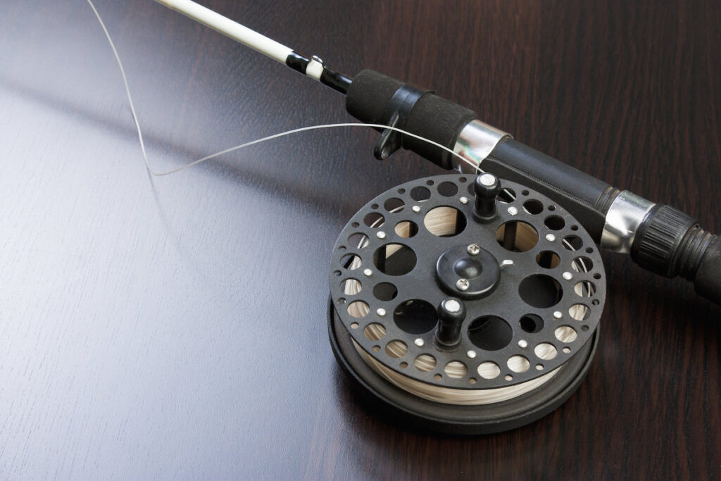 fly fishing reel attached to rod