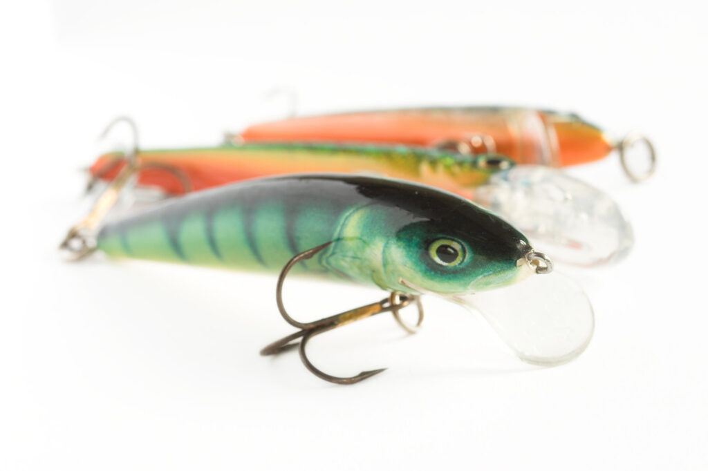 three traditional fishing lures lined up